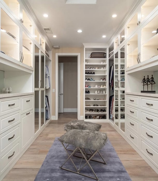 large walk-in closet with padded seats